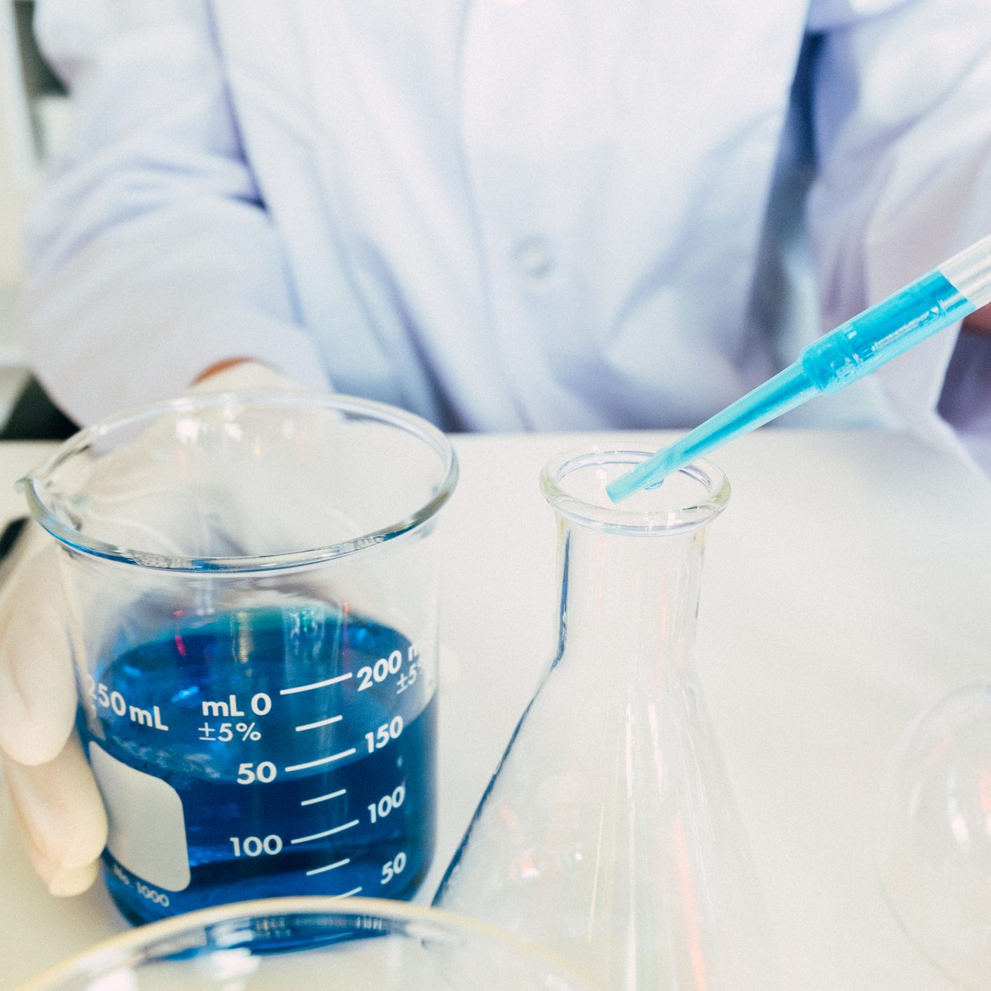 scientist in the laboratory working at lab with test tubes
